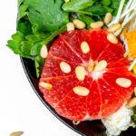 Close-up salad with grapefruit, avocado, micro greenery and pine nuts